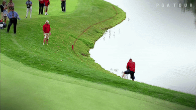 GIF of Woody Austin falling into the water after hitting his golf shot at the Presidents Cup in 2007.