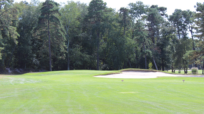 The approach and green with a sand bunker on the right side of the green. This is Hole No. 3 at Buena Vista Country Club.